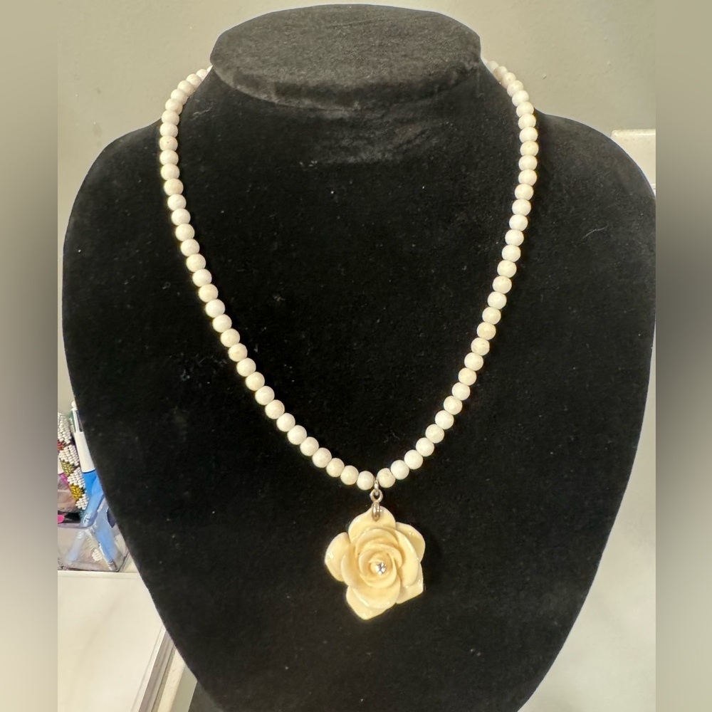 White coral beads and flower choker with crystal center stone.